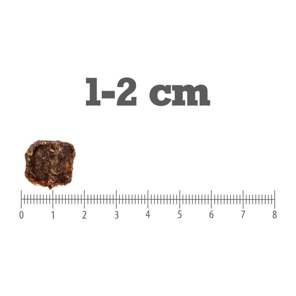 Pamlsek nad pravítkem s dělením na centimetry, nad ním nápis „1-2 cm“